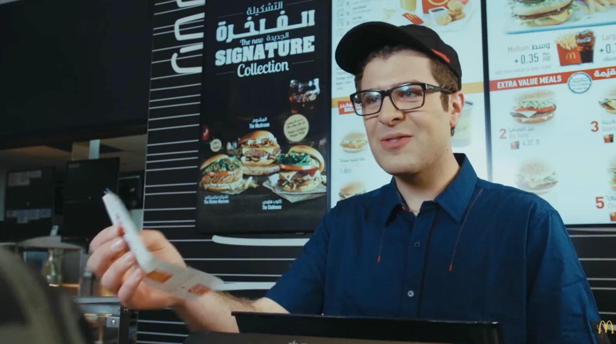 Robert Abboud as a cashier in a McDonald's commercial, 2018