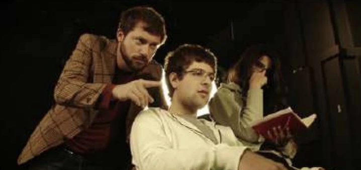 Robert Abboud in a dramatic scene with two actors